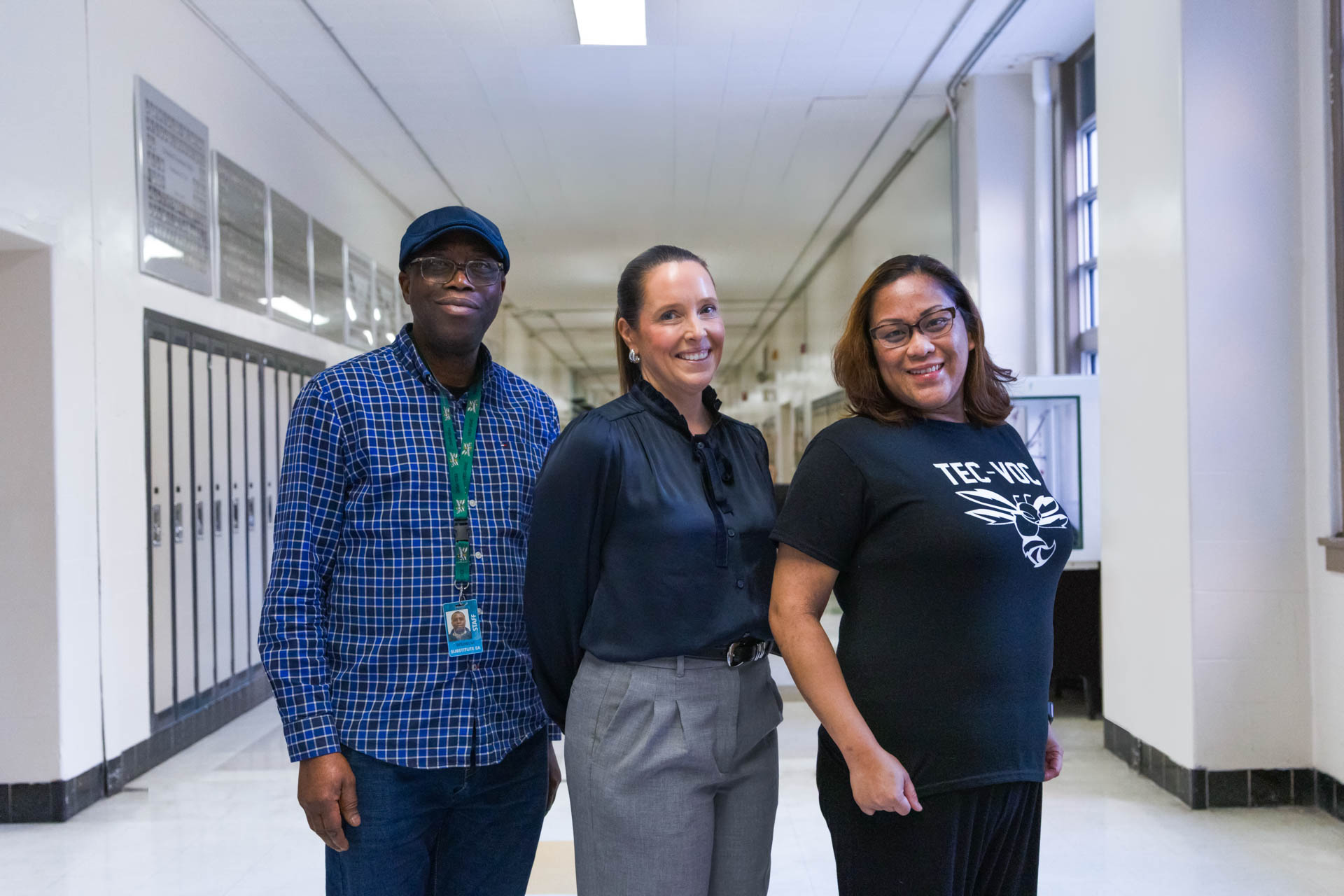 Smiling educational staff standing in hallway at Winnipeg School Division high school