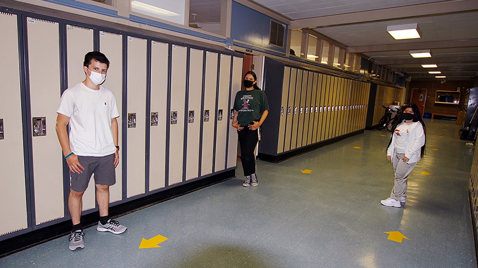 Three Summer Session students outside their classroom
