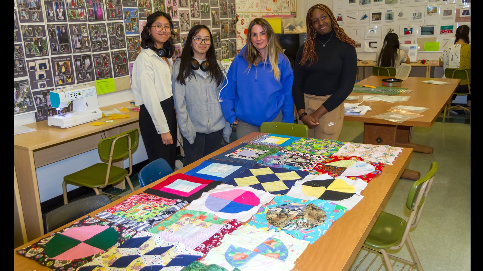 Ms. Jenna Forslund and three students are showcasing the different patterns students have created for the quilt.