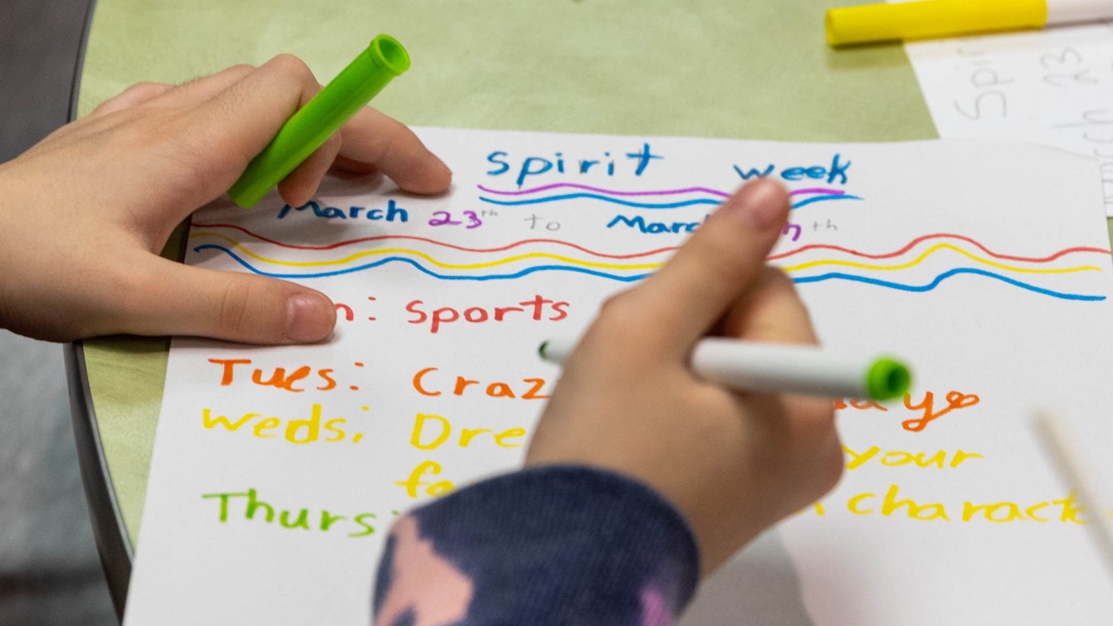 Confidence Crew students working on Spirit Week posters.