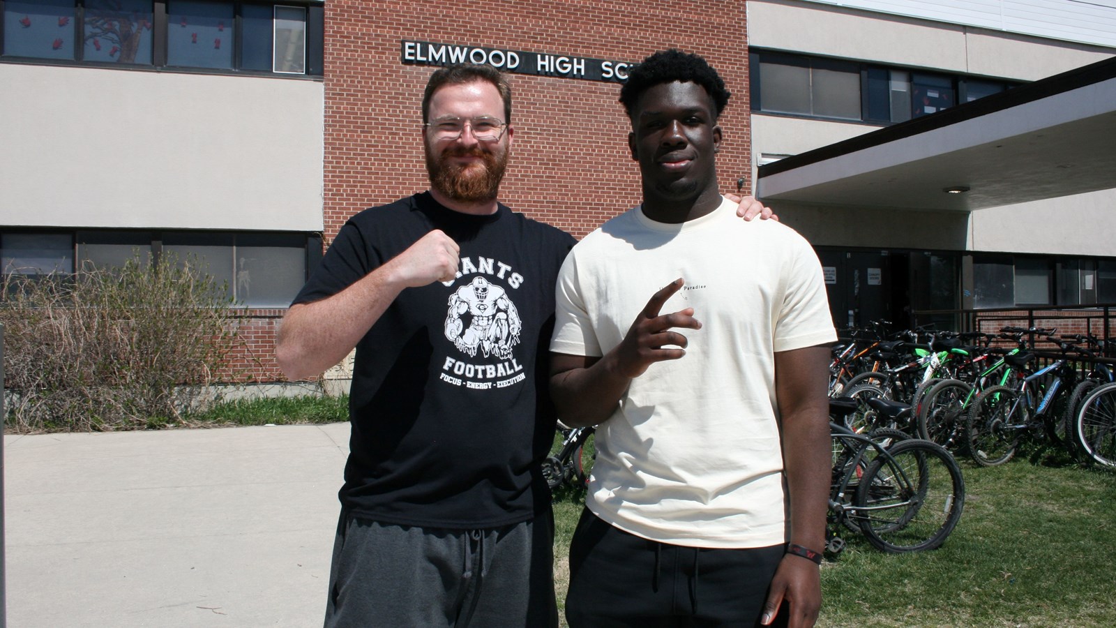 Thiery Moro with the Elmwood football coach John Kiesman.